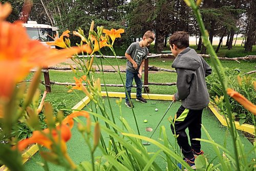 14072023
Cousins Micah Sawatzky and Kyle Sawatzky play mini golf together at Cj's Snack Shack and Mini Golf in Rivers Provincial Park on a smoky Friday afternoon.  (Tim Smith/The Brandon Sun)