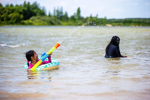 MIKAELA MACKENZIE / WINNIPEG FREE PRESS

Juliette Daquil (seven) plays in the water at the beach at Bird&#x573; Hill Provincial Park, which has now been raked but previously had complaints about excessive goose poop, on Friday, July 14, 2023. For Danielle story.
Winnipeg Free Press 2023.