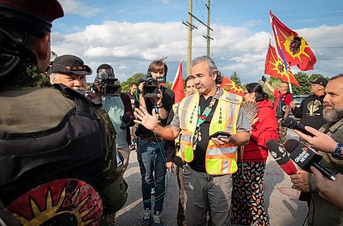 JESSICA LEE / WINNIPEG FREE PRESS

A police liaison is photographed chatting with protestors at Brady Landfill July 14, 2023 after he tells them they have to leave.

Reporter: Chris Kitching