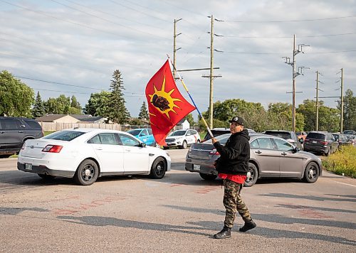 JESSICA LEE / WINNIPEG FREE PRESS

A protestor waves a flag as unmarked police cars arrive at Brady Landfill July 14, 2023.

Reporter: Chris Kitching