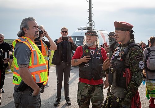 JESSICA LEE / WINNIPEG FREE PRESS

A police liaison tells Joseph Munro (in red) that protestors must leave Brady Landfill July 14, 2023.

Reporter: Chris Kitching