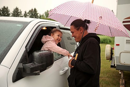 14072023
Ira McNab of Regina visits with his daughter Rosie while waiting for light showers to stop during the Sioux Valley Dakota Nation Dakota Oyate Wacipi Powwow on Friday evening.
(Tim Smith/The Brandon Sun)