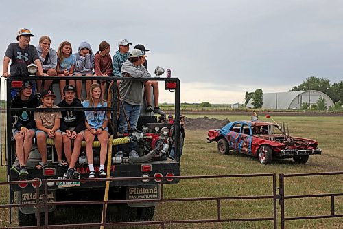 15072023
Kids pack the back of a fire engine to watch cars enter the ring during a heat at the demolition derby at the end of the Deloraine Summer Fair on Saturday evening. Nine cars competed in the derby in front of a packed grandstand of fair-goers. The event included two heats, a consolation round and a final. The fair also included a steak fry, live music, kids events, a cornhole tournament and other activities.
(Tim Smith/The Brandon Sun)