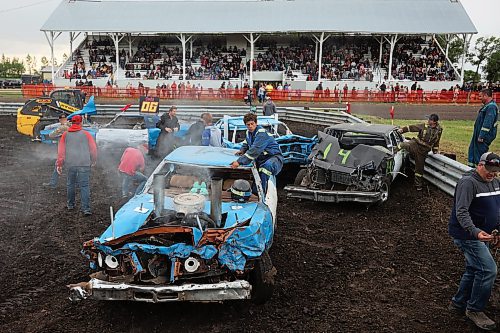 15072023
Competitors get out of their smoking, crushed cars after a heat at the Deloraine Summer Fair demolition derby on Saturday evening. Nine cars competed in the derby in front of a packed grandstand of fair-goers. The event included two heats, a consolation round and a final. The fair also included a steak fry, live music, kids events, a cornhole tournament and other activities.
(Tim Smith/The Brandon Sun)