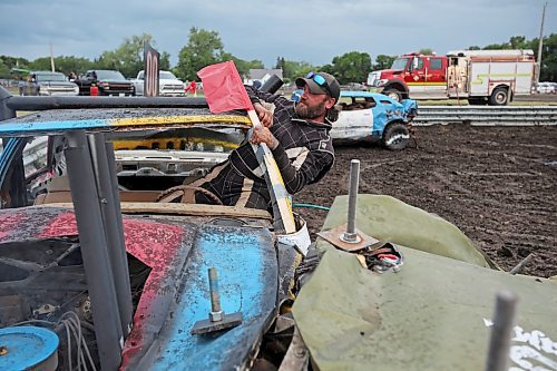 15072023
Tom Hammond of Boissevain crawls out the window of chis car after the demolition derby final at the end of the Deloraine Summer Fair on Saturday evening. Nine cars competed in the derby in front of a packed grandstand of fair-goers. 
(Tim Smith/The Brandon Sun)