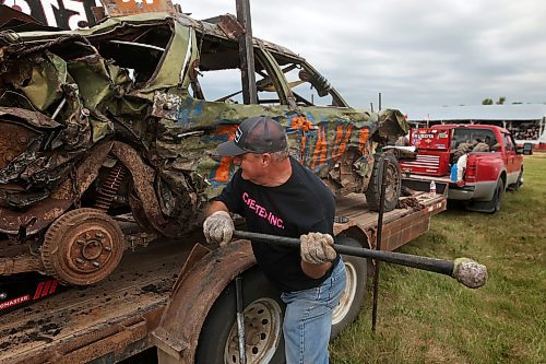 15072023
Brian Prysiazniuk helps work on Rob Prettie&#x2019;s car during the Deloraine Summer Fair demolition derby on Saturday evening. Nine cars competed in the derby in front of a packed grandstand of fair-goers. The event included two heats, a consolation round and a final. The fair also included a steak fry, live music, kids events, a cornhole tournament and other activities.
(Tim Smith/The Brandon Sun)