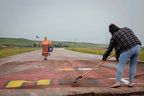 JESSICA LEE / WINNIPEG FREE PRESS
A protestor cleans the mural on the road to Brady Landfill while another protestor sings July 18, 2023 after the removal of the blockade at Brady Landfill earlier that morning.
Reporter: Chris Kitching