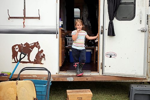 18072023
Five-year-old Victoria Thiessen of Oak Lake looks out from the doorway of her family&#x2019;s trailer while they show horses as part of the 135th Annual Strathclair Ag Society Fair on Tuesday. The Strathclair Ag Society Fair is one of six stops for the annual Milk Run, a six day long series of town fairs in close proximity. The other fairs include Oak River, Shoal Lake, Hamiota, Harding and Oak Lake. The Strathclair fair included a light horse show, a beef show, a heavy horse driving demonstration and a wide variety of entertainment, games and other activities. 
(Tim Smith/The Brandon Sun)