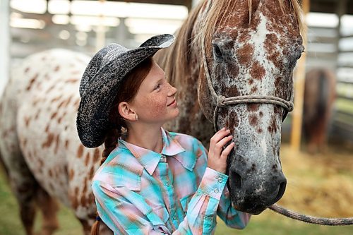 18072023
Cassie Dudar, eleven, visits with appaloosa horse Charlie during the 135th Annual Strathclair Ag Society Fair on Tuesday. The Strathclair Ag Society Fair is one of six stops for the annual Milk Run, a six day long series of town fairs in close proximity. The other fairs include Oak River, Shoal Lake, Hamiota, Harding and Oak Lake. The Strathclair fair included a light horse show, a beef show, a heavy horse driving demonstration and a wide variety of entertainment, games and other activities. 
(Tim Smith/The Brandon Sun)