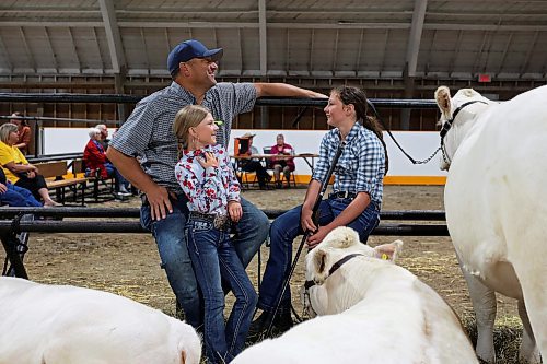 18072023
Shawn Airey and his daughter Blake, 10, visit with family friend Myra Ramsey as they sit with their charolais cattle during the 135th Annual Strathclair Ag Society Fair on Tuesday. The Strathclair Ag Society Fair is one of six stops for the annual Milk Run, a six day long series of town fairs in close proximity. The other fairs include Oak River, Shoal Lake, Hamiota, Harding and Oak Lake. The Strathclair fair included a light horse show, a beef show, a heavy horse driving demonstration and a wide variety of entertainment, games and other activities. 
(Tim Smith/The Brandon Sun)