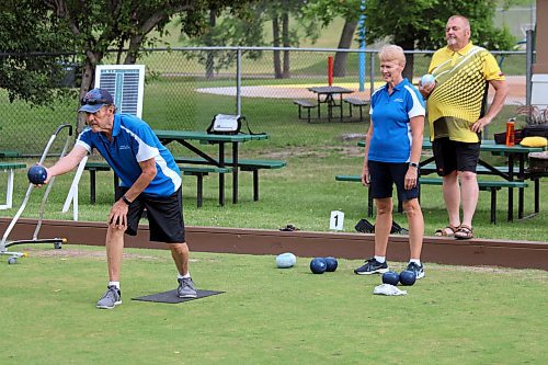 Kevin Foley prepares to make a throw while Kathy Foley and Rod Rose watch on at the Wheat City Lawn Bowling Club on Tuesday night. All three will be competing for Manitoba at national championships later this summer. (Lucas Punkari/The Brandon Sun)