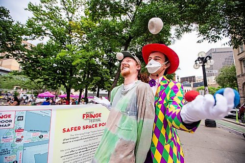 MIKAELA MACKENZIE / WINNIPEG FREE PRESS

Louis Stevens (left) and T8 the Gr8 (Tait Palsson) do juggling tricks outside of Old Market Square at the launch of Fringe Festival on Wednesday, July 19, 2023. Standup.
Winnipeg Free Press 2023.