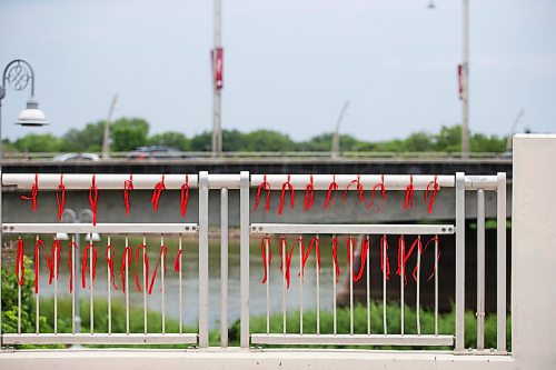 MIKAELA MACKENZIE / WINNIPEG FREE PRESS

Red ribbons with the names of missing and murdered Indigenous women on the railing at the Louis Riel Bridge by Camp Marcedes on Wednesday, July 19, 2023. For Chris story.
Winnipeg Free Press 2023.