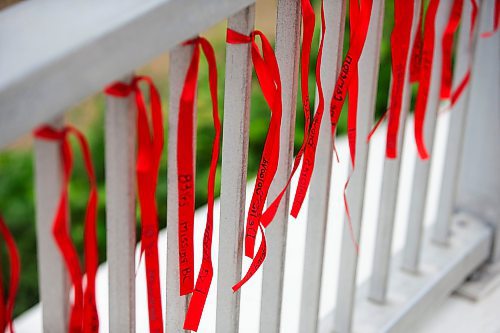 MIKAELA MACKENZIE / WINNIPEG FREE PRESS

Red ribbons with the names of missing and murdered Indigenous women on the railing at the Louis Riel Bridge by Camp Marcedes on Wednesday, July 19, 2023. For Chris story.
Winnipeg Free Press 2023.