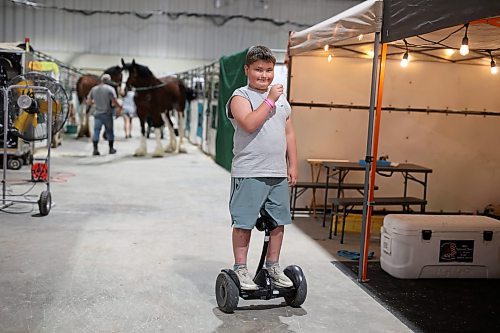 19072023
Kelton Stade with Terry Stade Farms in Minnesota rides a Segway around the Stade&#x2019;s stalls during the 2023 World Clydesdale Show at the Keystone Centre in Brandon on Wednesday.
(Tim Smith/The Brandon Sun)