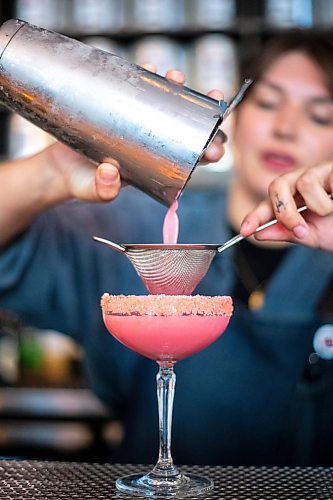 MIKAELA MACKENZIE / WINNIPEG FREE PRESS

Melaney Droguett makes a Malibu Barbie cocktail at the Amsterdam Tea House on Wednesday, July 12, 2023.  For AV Kitching story.
Winnipeg Free Press 2023.