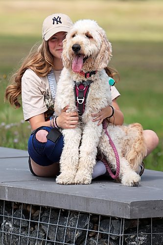 Addie Dunwoody sits with her golden Labradoodle Nirvana at the Riverbank Discovery Centre on Thursday.
(Tim Smith/The Brandon Sun)