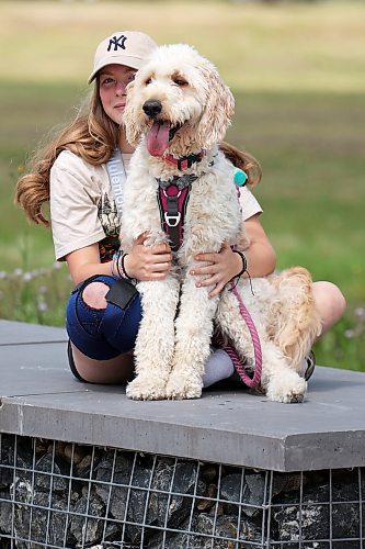 20072023
Addie Dunwoody sits with her golden Labradoodle Nirvana at the Riverbank Discovery Centre on Thursday.
(Tim Smith/The Brandon Sun)