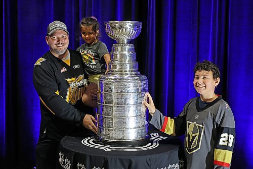 Martin Paradis and his children Lennon and Ashton have their photo taken with the Stanley Cup during a public event with the trophy and Vegas Golden Knights general manager Kelly McCrimmon at the Keystone Centre on Friday. McCrimmon had the trophy in Brandon for the whole day, bringing it to a series of public and private events. Thousands lined up throughout the morning to see the cup up close and meet with McCrimmon. (Tim Smith/The Brandon Sun)