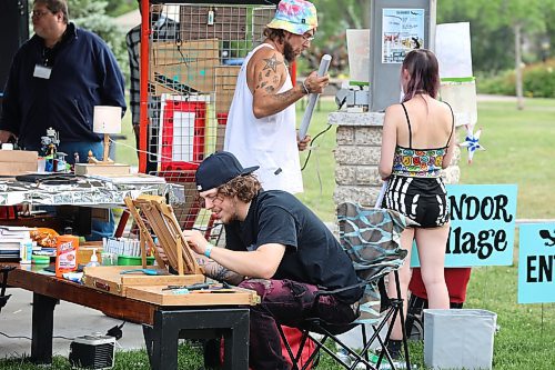 Parker Gabrielle of Lucid Dreaming Designs sketches some caricatures at Rideau Park during the opening night of the inaugural Salamander Summer Music Festival. The music festival features a variety of artisans and vendors who are selling their wares near the entrance to the park. (Kyle Darbyson/The Brandon Sun)