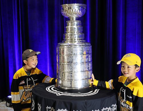 21072023
Twin siblings Logan and Ethan Ding have their photo taken with the Stanley Cup during a public event with the trophy and Vegas Golden Knights general manager Kelly McCrimmon at the Keystone Centre on Friday. McCrimmon had the trophy in Brandon for the whole day, bringing it to a series of public and private events. Thousands lined up throughout the morning to see the cup up close and meet with McCrimmon. (Tim Smith/The Brandon Sun)