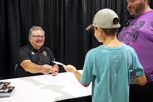 21072023
Vegas Golden Knights' general manager and former Brandon Wheat Kings owner, general manager and coach Kelly McCrimmon signs an autograph for Jordan Swain at the Keystone Centre on Friday morning during a public event with the Stanley Cup trophy. McCrimmon had the trophy in Brandon for the whole day, bringing it to a series of public and private events. Thousands lined up throughout the morning to see the cup up close and meet with McCrimmon. (Tim Smith/The Brandon Sun)