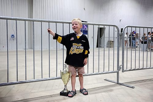 21072023
Six-year-old Finn Derlago waits with his 2023 Portage Cup spring tournament trophy to see the Stanley Cup during a public event with the trophy and Vegas Golden Knights general manager Kelly McCrimmon at the Keystone Centre on Friday. McCrimmon had the trophy in Brandon for the whole day, bringing it to a series of public and private events. Thousands lined up throughout the morning to see the cup up close and meet with McCrimmon. (Tim Smith/The Brandon Sun)