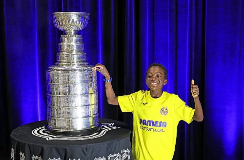 21072023
Damilola Afolabi poses for photos with the Stanley Cup during a public event with the trophy and Vegas Golden Knights general manager Kelly McCrimmon at the Keystone Centre on Friday. McCrimmon had the trophy in Brandon for the whole day, bringing it to a series of public and private events. Thousands lined up throughout the morning to see the cup up close and meet with McCrimmon. (Tim Smith/The Brandon Sun)