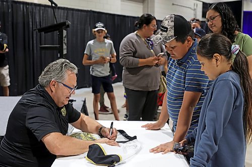 21072023
Vegas Golden Knights' general manager and former Brandon Wheat Kings owner, general manager and coach Kelly McCrimmon signs autographs for siblings Nolan and Anna Amyotte at the Keystone Centre on Friday morning during a public event with the Stanley Cup trophy. McCrimmon had the trophy in Brandon for the whole day, bringing it to a series of public and private events. Thousands lined up throughout the morning to see the cup up close and meet with McCrimmon. (Tim Smith/The Brandon Sun)