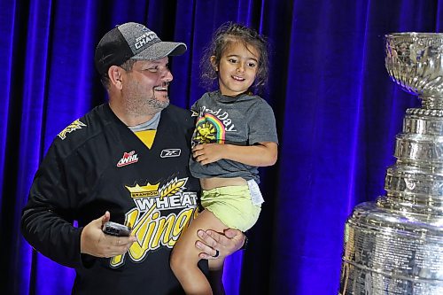 21072023
Martin Paradis and his daughter Lennon look over the Stanley Cup during a public event with the trophy and Vegas Golden Knights general manager Kelly McCrimmon at the Keystone Centre on Friday. McCrimmon had the trophy in Brandon for the whole day, bringing it to a series of public and private events. Thousands lined up throughout the morning to see the cup up close and meet with McCrimmon. (Tim Smith/The Brandon Sun)