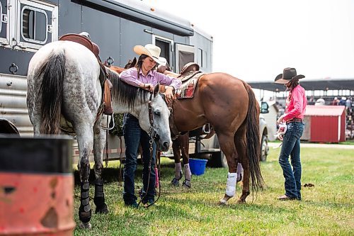 MIKAELA MACKENZIE / WINNIPEG FREE PRESS

Mariah Mannering (left) and Lane Wills get their horses ready for the barrel racing event at the Manitoba Stampede in Morris on Saturday, July 22, 2023. For Tyler story.
Winnipeg Free Press 2023