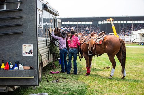 MIKAELA MACKENZIE / WINNIPEG FREE PRESS

Mariah Mannering (left) and Lane Wills get their horses ready for the barrel racing event at the Manitoba Stampede in Morris on Saturday, July 22, 2023. For Tyler story.
Winnipeg Free Press 2023