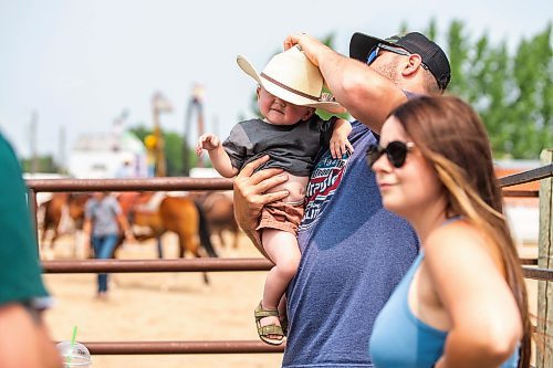 MIKAELA MACKENZIE / WINNIPEG FREE PRESS

Cody Krentz puts a cowboy hat on his one-year-old, Riggin Krentz, at the Manitoba Stampede in Morris on Saturday, July 22, 2023. For Tyler story.
Winnipeg Free Press 2023