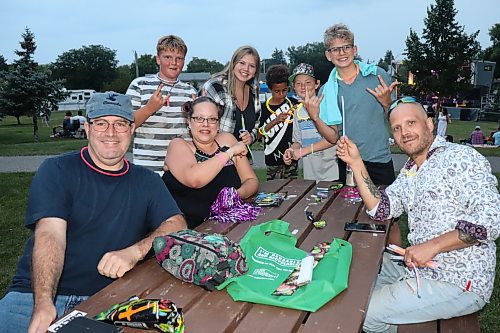 Attendees get busy assembling glow sticks at Rideau Park as the sun sets on the first day of the festival on Friday. (Kyle Darbyson/The Brandon Sun)