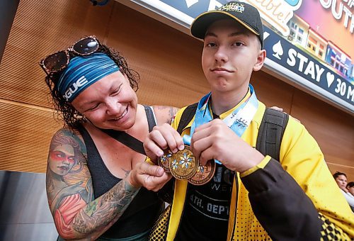 JOHN WOODS / WINNIPEG FREE PRESS
Christy Anderson checks out her son Riley&#x2019;s medals for swimming on the U16 Manitoba team as he returns from the North American Indigenous Games in Halifax at Winnipeg&#x2019;s airport, Sunday, July 23, 2023. 

Reporter: ?