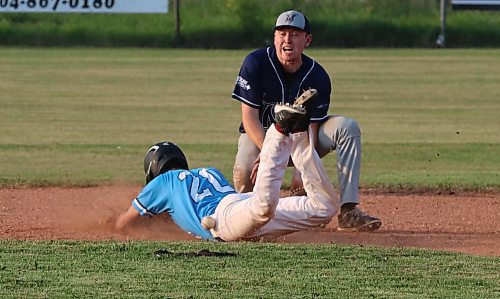 The ball hits Carberry Royals base runner Russell Adriaansen (20) on the hip as he dives into second for a stolen base in front of Minnedosa Mavericks shortstop Lyndon Zimmer (14) during Game 2 of their Santa Clara Baseball League semifinal series on Monday evening at Glennis Scott Field in Minnedosa. The Mavericks completed a two-game sweep with a 7-4 victory. The Royals, who won the regular season title, had the tying run on first base in the bottom of the seventh inning. (Perry Bergson/The Brandon Sun)