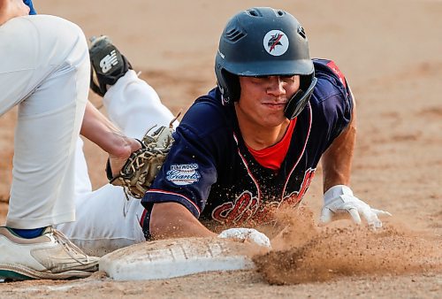 JOHN WOODS / WINNIPEG FREE PRESS
Elmwood Giants&#x2019; Brett Lucko (40) beats the throw to first against the St Boniface Legionaires in game one of the best of five MJBL championship series at Koskie Field in Winnipeg, Monday, July 24, 2023. 

Reporter: frey-sam