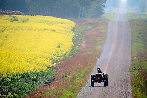 24072023
A farmer rides a tractor along a grid road south of Erickson on a smoky Monday morning. (Tim Smith/The Brandon Sun)