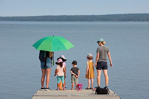 24072023
Clara Suresh-Mills, Adelaide Suresh-Mills, Jasper Pilloud and Olive Pilloud try to catch lake creatures from the end of a dock at the boat launch on Clear Lake in Wasagaming as their moms Amanda Pilloud (L) and Chelsea Suresh-Mills (R) supervise on a hot Monday. (Tim Smith/The Brandon Sun)