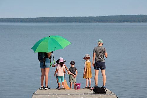 24072023
Adelaide Suresh-Mills, Clara Suresh-Mills, Jasper Pilloud and Olive Pilloud try to catch lake creatures from the end of a dock at the boat launch on Clear Lake in Wasagaming as their moms Amanda Pilloud (L) and Chelsea Suresh-Mills (R) supervise on a hot Monday. (Tim Smith/The Brandon Sun)