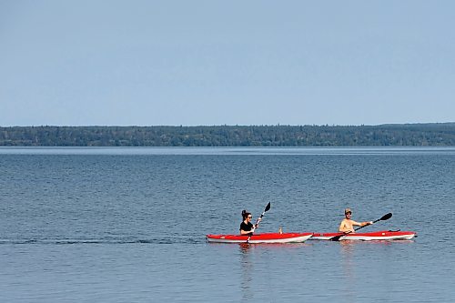 24072023
Kayakers paddle through the water at Clear Lake in Riding Mountain National Park on a hot Monday. (Tim Smith/The Brandon Sun)