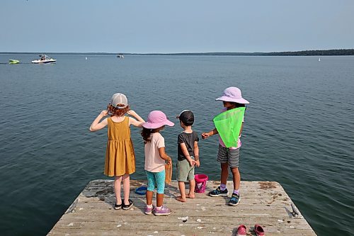 24072023
Olive Pilloud, Clara Suresh-Mills, Jasper Pilloud and Adelaide Suresh-Mills try to catch lake creatures from the end of a dock at the boat launch on Clear Lake in Wasagaming on a hot Monday. (Tim Smith/The Brandon Sun)