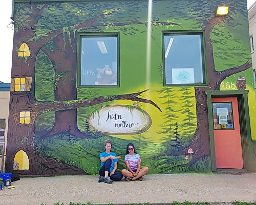 Local artists Katy Martin and Meghan Peters left their artistic stamp on the outside of local toy store Hid'n Hollow on the weekend on July 22 and 23. (Miranda Leybourne/The Brandon Sun)