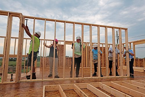 Steadying the party wall during the Women Build for Habitat for Humanity, in the 700 Block of Franklin Street in Brandon on Tuesday. (Michele McDougall/The Brandon Sun)
