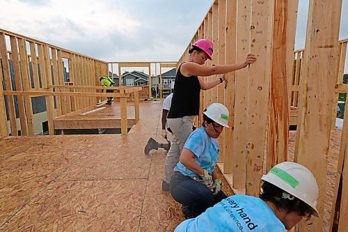 Holding the party wall in place during the Women Build for Habitat for Humanity, in the 700 Block of Franklin Street in Brandon on Tuesday. (Michele McDougall/The Brandon Sun)
