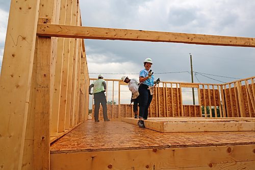 Volunteer Leah Peterson waves during the Women Build for Habitat for Humanity, in the 700 Block of Franklin Street in Brandon on Tuesday. (Michele McDougall/The Brandon Sun)