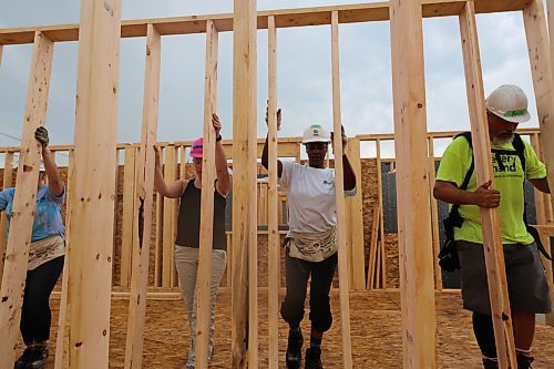 Securing the party wall during the Women Build for Habitat for Humanity, in the 700 Block of Franklin Street in Brandon on Tuesday. (Michele McDougall/The Brandon Sun)