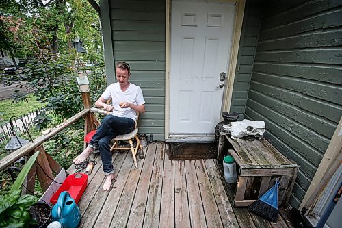 JOHN WOODS / WINNIPEG FREE PRESS
Nathan Enns, prop master in the Manitoba film industry, whittles on his front deck in Winnipeg, Tuesday, July 25, 2023. The industry strike in the US seems to be indirectly affecting the Manitoba film industry. Manitoba&#x2019;s film production has ground to a halt.

Reporter: ?