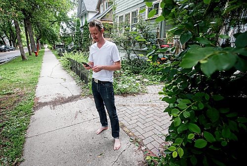 JOHN WOODS / WINNIPEG FREE PRESS
Nathan Enns, prop master in the Manitoba film industry, checks his phone infront of his house in Winnipeg, Tuesday, July 25, 2023. The industry strike in the US seems to be indirectly affecting the Manitoba film industry. Manitoba&#x2019;s film production has ground to a halt.

Reporter: ?