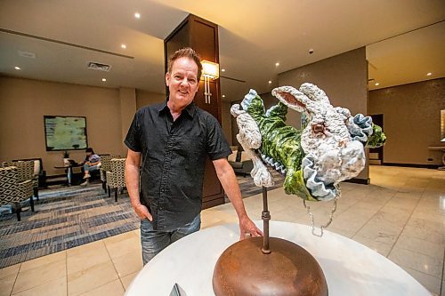 MIKAELA MACKENZIE / WINNIPEG FREE PRESS

Fairmont artist-in-residence Charlie Johnston with his sculpture in the hotel lobby in Winnipeg on Tuesday, July 25, 2023. For Al Small story.
Winnipeg Free Press 2023